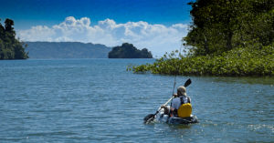 A man Kayaking and fishing in the water of the Golfo Dulce, Osa Peninsula